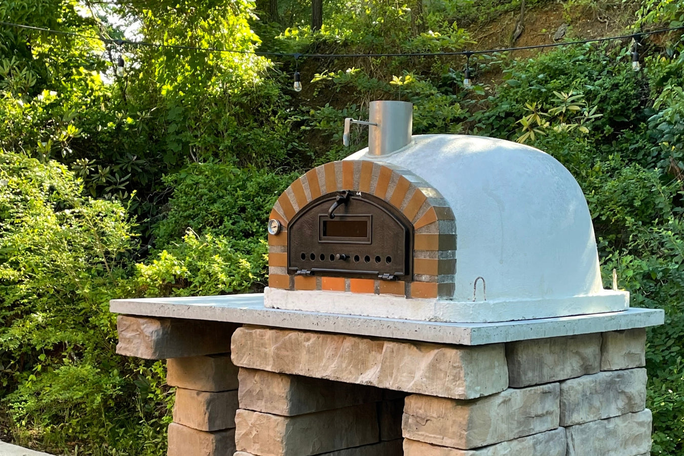 authentic pizza oven from traditional range with log storage in garden