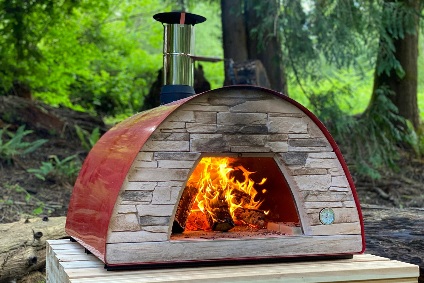 modern red authentic pizza oven on pallet bench stand